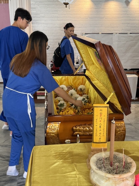 laying flowers in the coffin